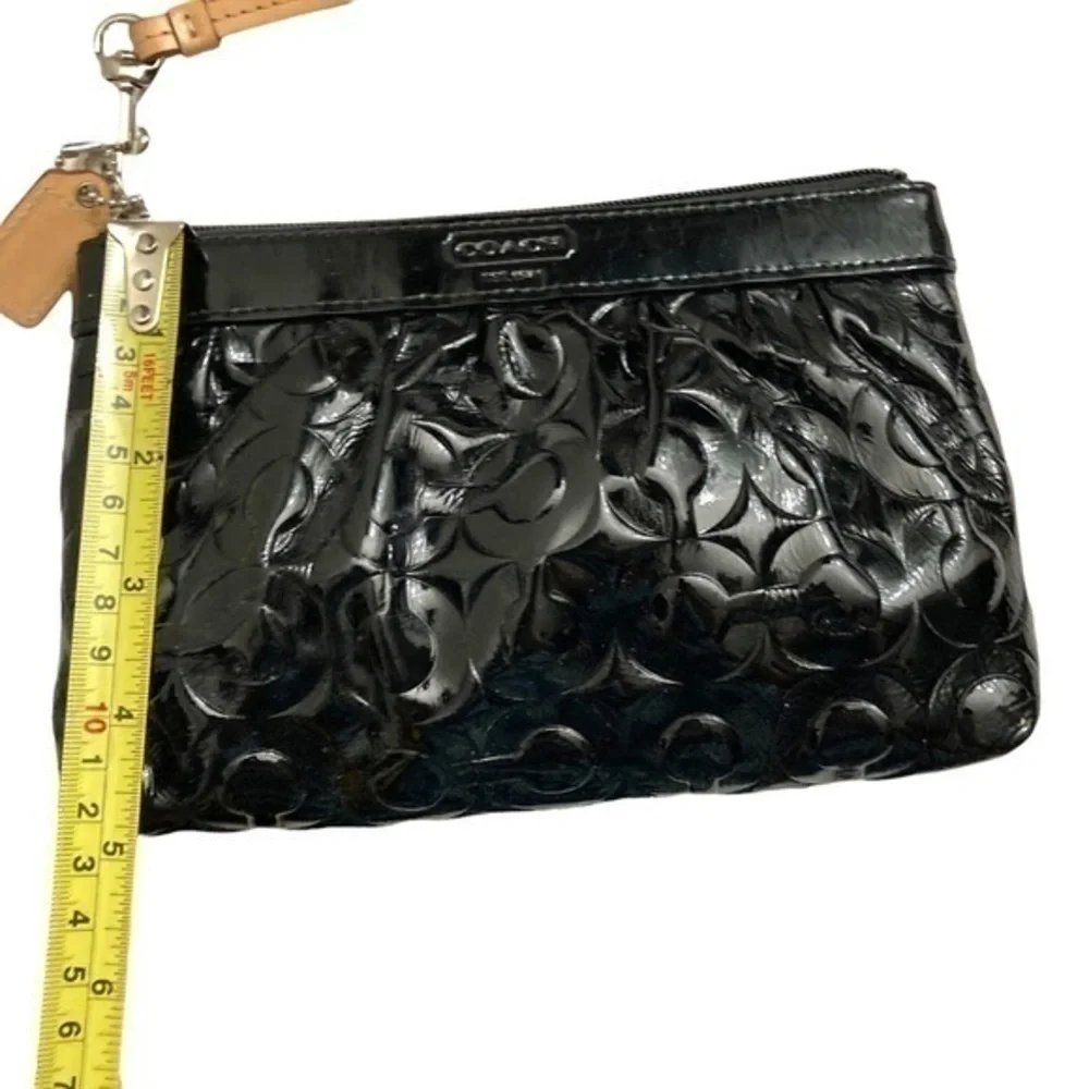 Coach embossed black patent leather op art wristlet bag
